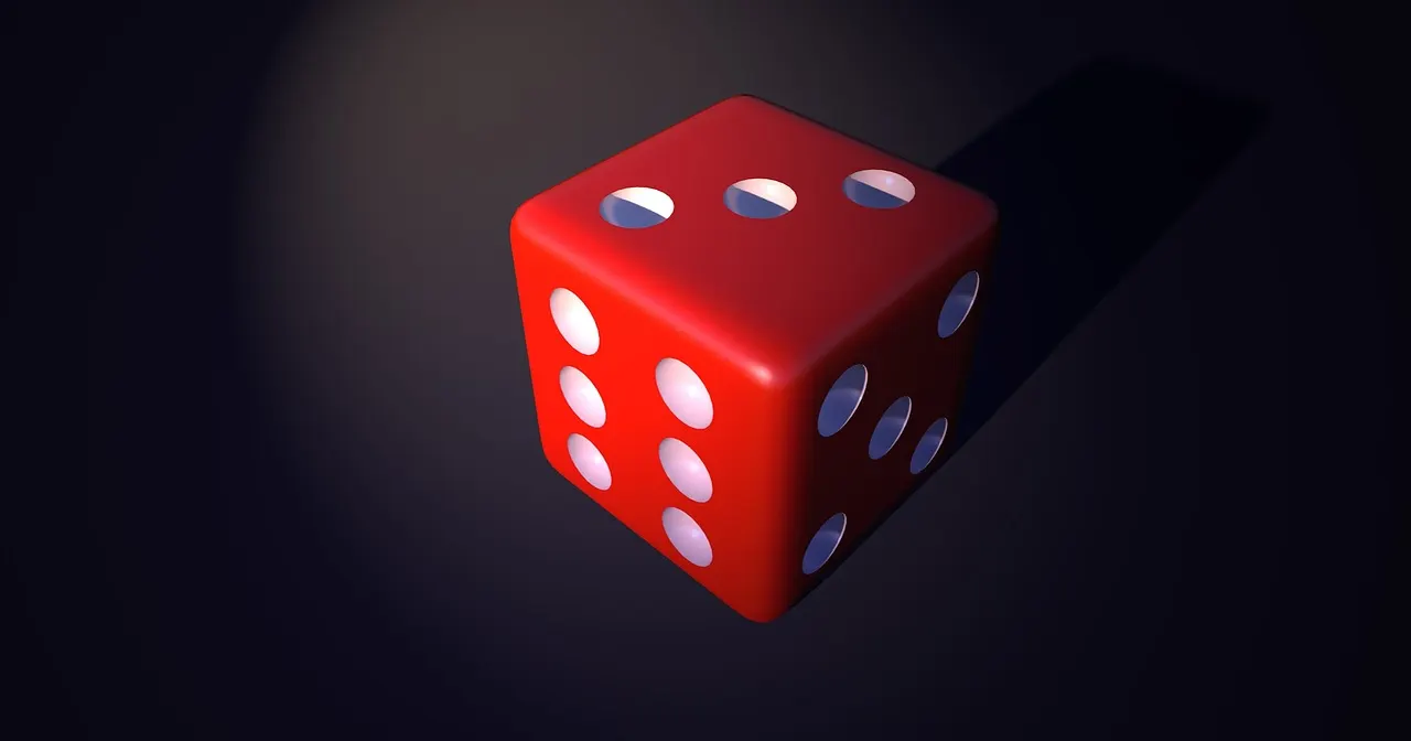Un dé rouge sur fond sombre
